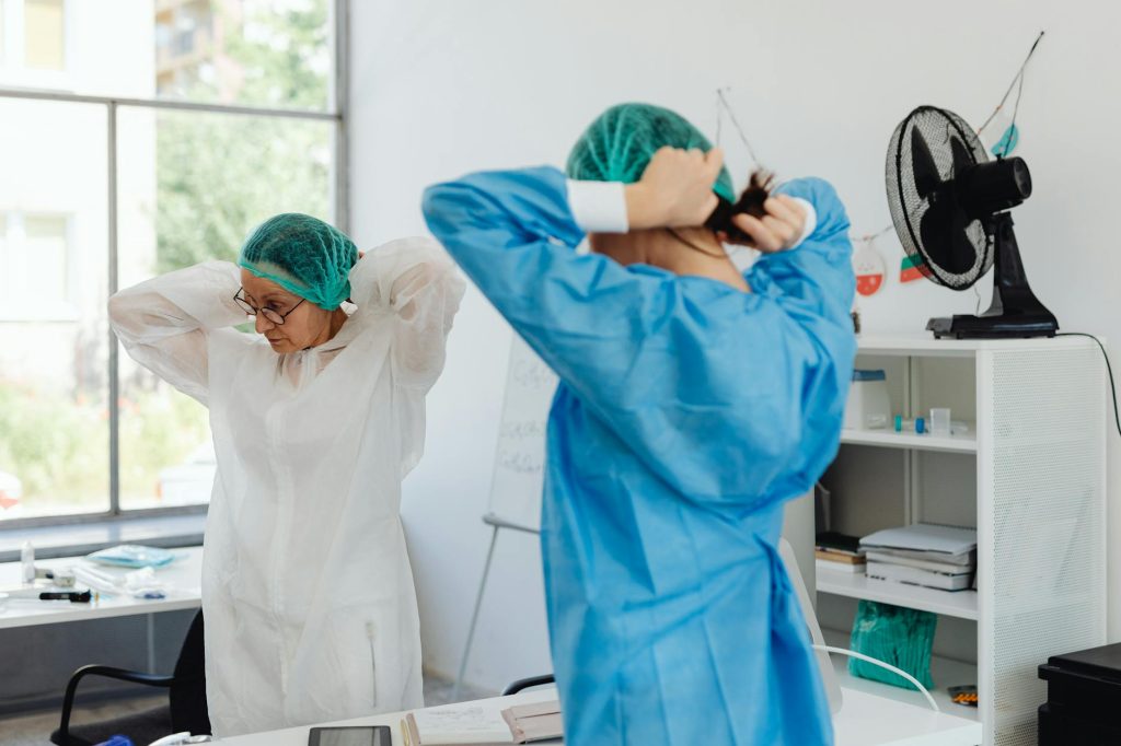 women wearing hairnets and scrub suit